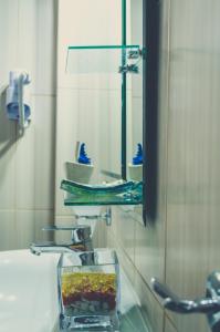 a bathroom with a sink with a bowl on the sink at Kiani Akti in Katelios