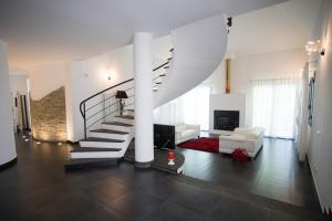 a living room with a spiral staircase in a house at Villa Margherita in Canicattini Bagni