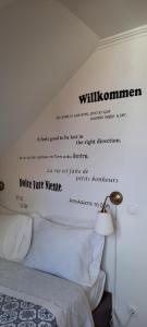 a bedroom with a bed with words on the wall at CasAzulApartments in Sintra