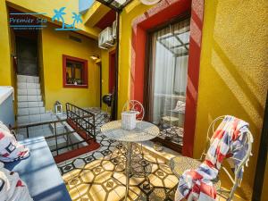 a patio with a table and chairs on a balcony at Carnagio All Season in Kavála