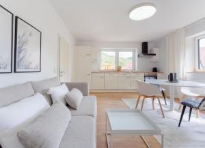 a white living room with a couch and a table at Perfektes Appartement für Erholung in der Wachau!! in Spitz