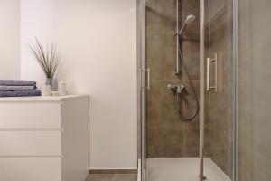 a shower with a glass door in a bathroom at Perfektes Appartement für Erholung in der Wachau!! in Spitz
