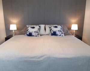 a bedroom with a large bed with blue and white pillows at Citykoti Kuutti in Savonlinna