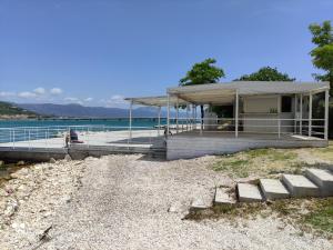 a house on a beach next to the water at Apartment Ella in Trogir