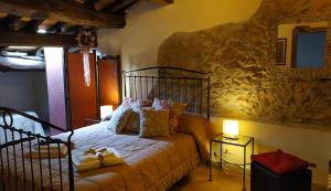 a bedroom with a bed and a stone wall at La Mora Exclusive in Moricone +72 photos
