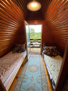 a small room with two beds and a doorway at Romantyczny zakątek w Wińcu in Winiec