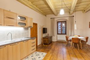 a kitchen with a table and a dining room at Babyka Apartments in Český Krumlov