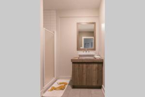a bathroom with a sink and a mirror at Le Grand Lodge - Locations du Sommet in Saint Adolphe D'Howard +22 photos