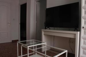 a living room with a television on a table at Casa José in Rota
