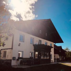 a large white building with a black roof at Ferien an der Traun in Traunwalchen