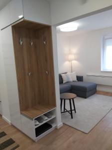 a living room with a cabinet and a couch at Hello apartman in Eger
