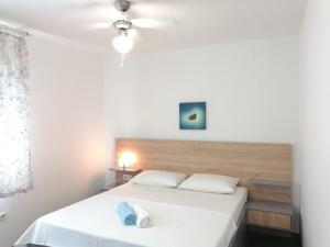 a bedroom with two beds with white sheets at Lovely Sea View House in Malinska Island Krk in Malinska