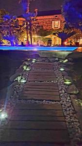 a stone walkway with lights on the street at night at La Casalamadonna in Santa-Lucia-di-Moriani