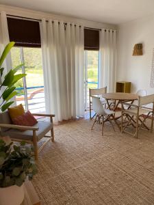 a living room with a table and chairs at Casa da Várzea in Odeceixe