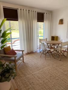 a living room with a table and chairs at Casa da Várzea in Odeceixe +40 photos