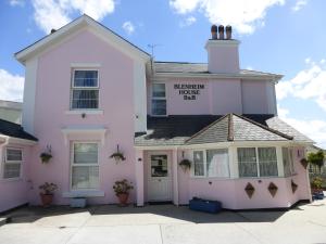 a pink house with a sign that reads bennington house bar at Blenheim House in Torquay