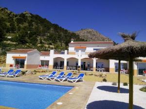 eine Villa mit einem Pool und blauen Liegestühlen in der Unterkunft Casa Pasamee in La Romana