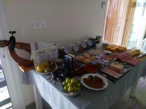 a table topped with lots of different types of food at Casa Pasamee in La Romana