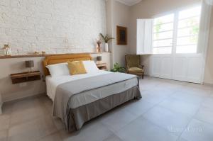 a bedroom with a large bed and a window at NEW HOME - appartamento in centro storico in Cagliari
