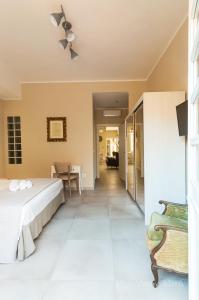 a bedroom with a bed and a dining room at NEW HOME - appartamento in centro storico in Cagliari