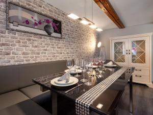 a dining room with a table and a brick wall at Flat in Elbingerode near the blue lake in Elbingerode