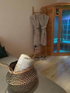 a room with a basket and clothes hanging on a wall at Sweet love exotique by Locations_lepuyenvelay in Brives-Charensac +10 photos
