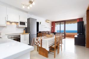 a kitchen and dining room with a view of the ocean at Looking the VIEWS - 214 in Costa Del Silencio