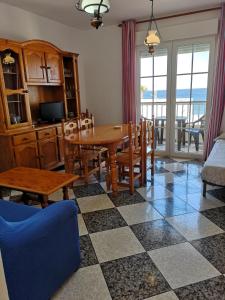 Una cocina y un comedor con mesa y sillas. en Apartamentos El Galán, en Carboneras