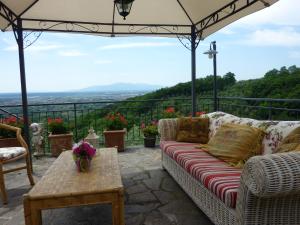 a patio with a couch and a table with a view at Agriturismo Campofiorito in Monsummano Terme