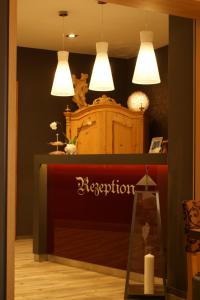 a shop with three lights hanging over a counter at Hotel Sonne - Das kleine Altstadt Hotel in Rothenburg ob der Tauber