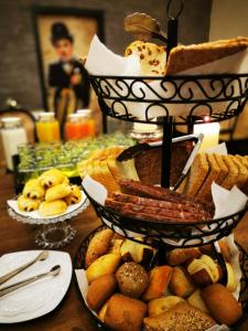 a table topped with three tiers of bread and pastries at Hotel Sonne - Das kleine Altstadt Hotel in Rothenburg ob der Tauber