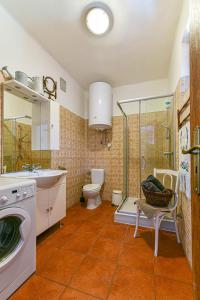 a bathroom with a washing machine and a toilet at Halháza vendégház in Sirok +100 photos