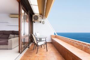 a balcony with a table and chairs and a couch at Looking the VIEWS - 214 in Costa Del Silencio