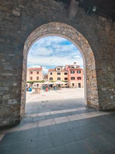 an archway in a brick wall with a courtyard at Apartma Mandala in Koper