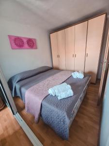 a bedroom with two beds with towels on it at Apartma Mandala in Koper