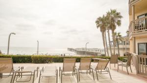 a patio with chairs and a view of the beach at Steps From The Sandy Pacific Beach in San Diego