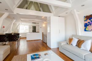 a living room with a couch and a table at B&B The Catch Apartment in Amsterdam