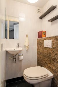 a bathroom with a toilet and a sink at B&B The Catch Apartment in Amsterdam