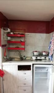 a small kitchen with a sink and a stove at Mini suites en el mejor sector de la ciudad in Quito