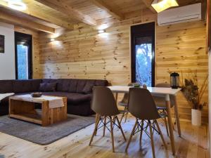 a living room with a couch and a table at OLEA COTTAGE in Ulcinj