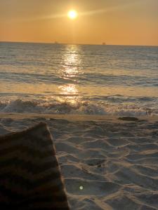 an american flag laying on the beach at sunset at Ritacuba House Boutique in Santa Marta