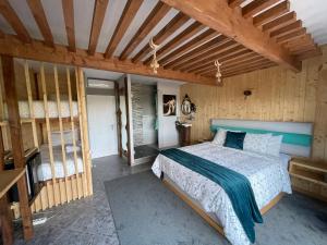 a bedroom with a bed in a room with wooden walls at Muas Guest House in Vila Real