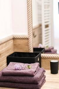 una pila de toallas púrpuras sentadas en una mesa en Apartamenty Oleńka II - Szczytno Mazury en Szczytno