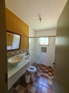 a bathroom with a sink and a toilet at Pousada Villa Aurora in Serra Negra