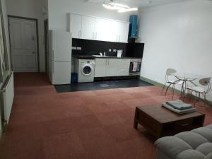 a kitchen with a refrigerator and a table in a room at Queen Suite in Ipswich