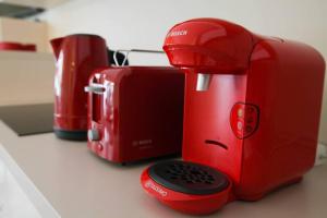 a red toaster and a toaster on a counter at Magnifique 3P - French riviera - 3mn beach - Air Conditioning - Balcony in Juan-les-Pins