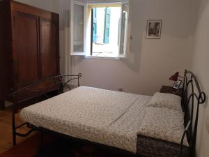 Ein Bett oder Betten in einem Zimmer der Unterkunft Il Nome della Rosa