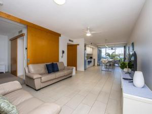 a living room with a couch and a table at 1 Bright Point Apartment 2204 in Nelly Bay