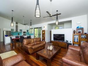 a living room with leather furniture and a table at Horseshoe Bay Vista in Horseshoe Bay