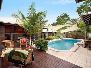 a backyard with a swimming pool and a wooden deck at Banyak Villa in Horseshoe Bay